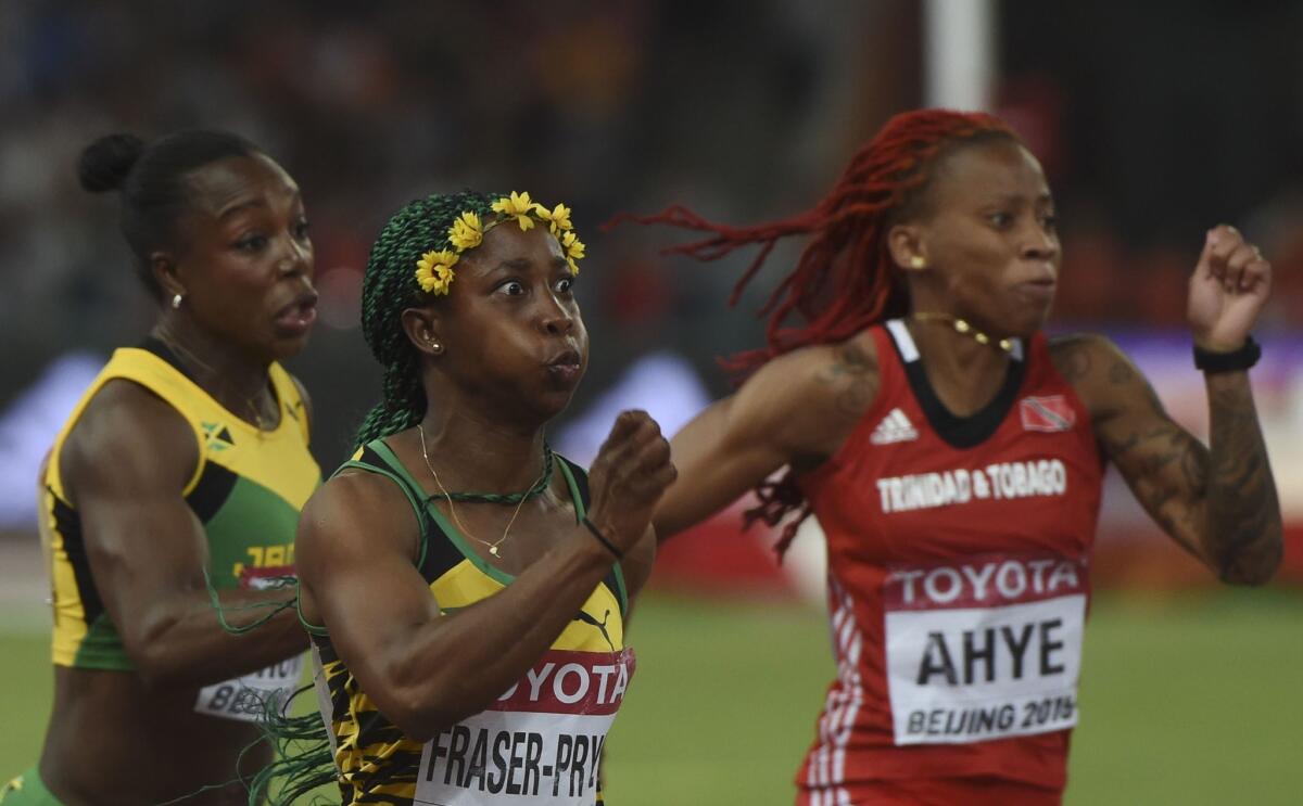 Jamaica's Shelly-Ann Fraser-Pryce, center, competes in the final of the women's 100 meters Monday at the world championships in Beijing.