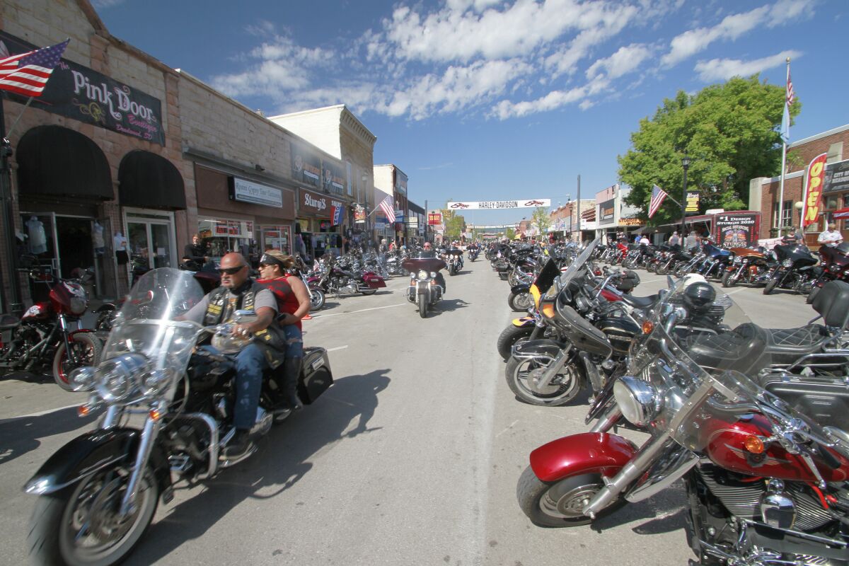 Thousands of bikers rode through the streets for the opening day of the 80th annual Sturgis Motorcycle rally Friday, Aug. 7, 2020, in Sturgis, S.D. (AP Photo/Stephen Groves)