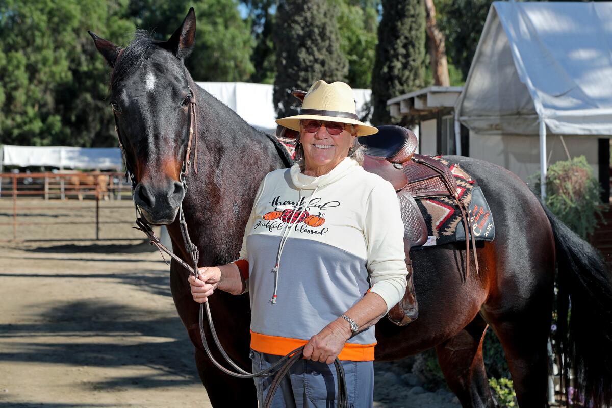 Kathy Holman joins her horse, Dixie, at Ortega Equestrian Center in San Juan Capistrano. 