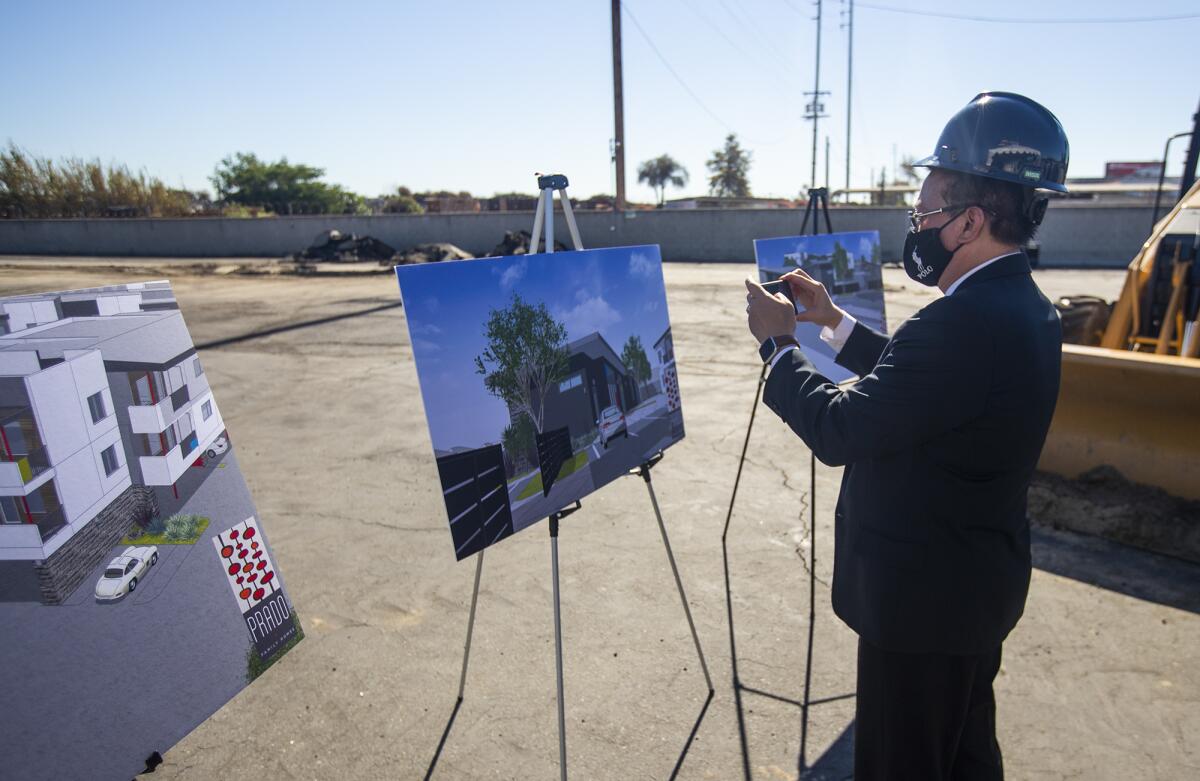 Fountain Valley Mayor Pro Tem Michael Vo takes pictures of Prado's renderings.