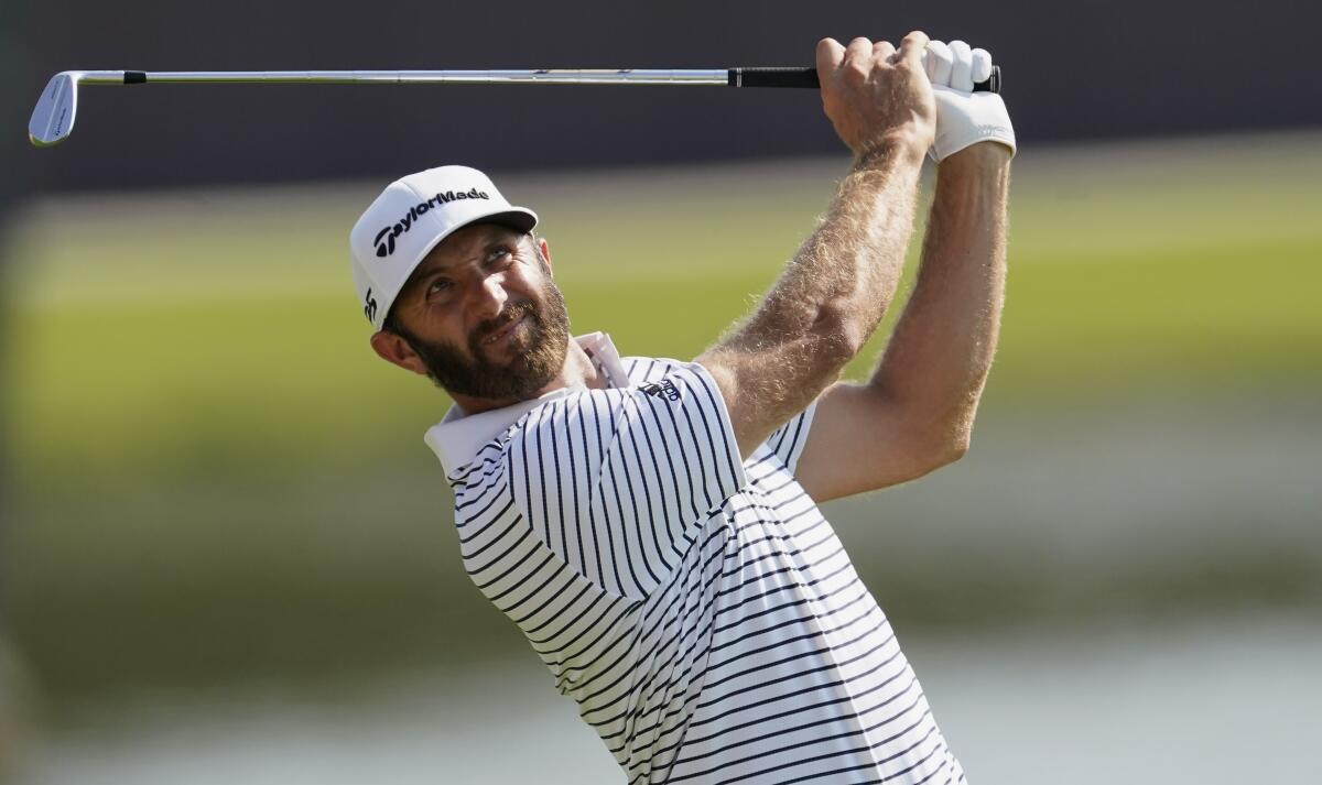 Dustin Johnson hits from the fairway on the eighth hole during the third round of the Tour Championship.