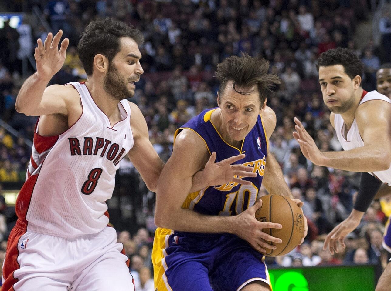 Lakers point guard Steve Nash drives past Raptors guard Jose Calderon, left, and forward Landry Fields in the second half Sunday.