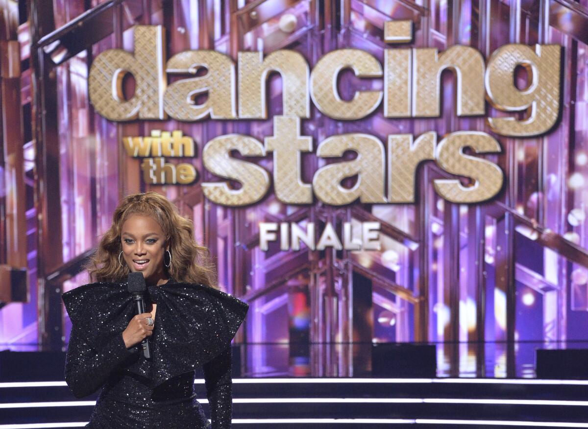 A woman onstage in front of sign that says 'Dancing With the Stars'