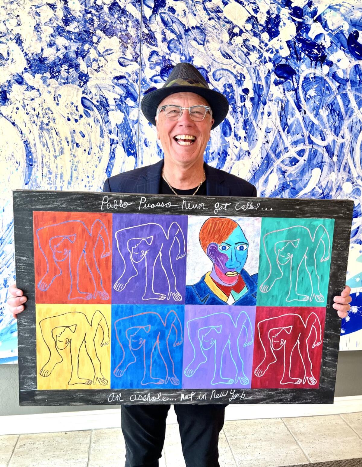 Artist Michael Robinson holds his piece "Dance Cadaverous" in the Legends Gallery of La Jolla.