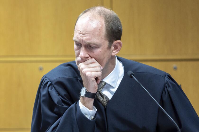 Fulton County Superior Court Judge Scott McAfee listens as he presides over a hearing regarding media access in the case against former President Donald Trump and 18 others at the Fulton County Courthouse in Atlanta, Thursday, Aug, 31, 2023. (Arvin Temkar/Atlanta Journal-Constitution via AP, Pool)