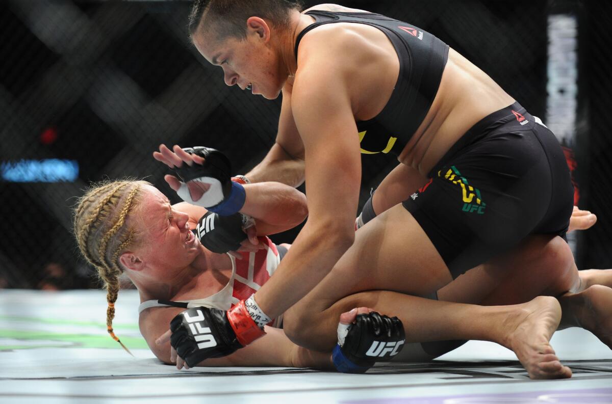 Amanda Nunes, top, battles Valentina Shevchenko during UFC 196 at MGM Grand Garden Arena in Las Vegas on March 5, 2016
