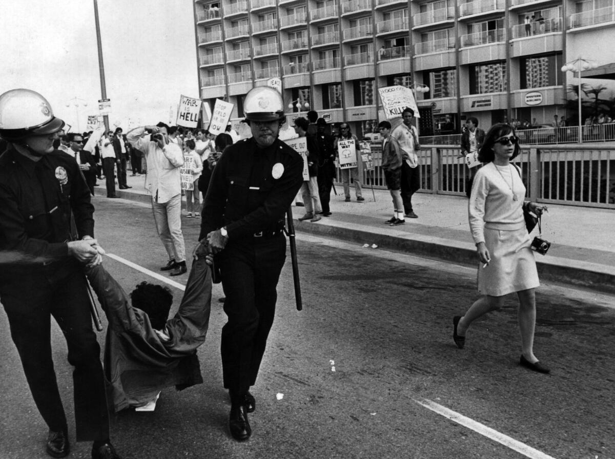 In 1967, LAPD officers remove a protester from the Century Plaza Hotel during an anti-Vietnam War demonstration where Democrats had gathered to hear President Lyndon Johnson.