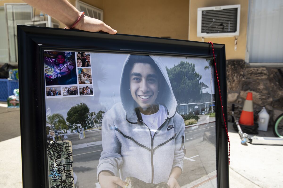 Daniel Flores, 18, shows photos of his younger brother, Omar Marquez Jr., 15
