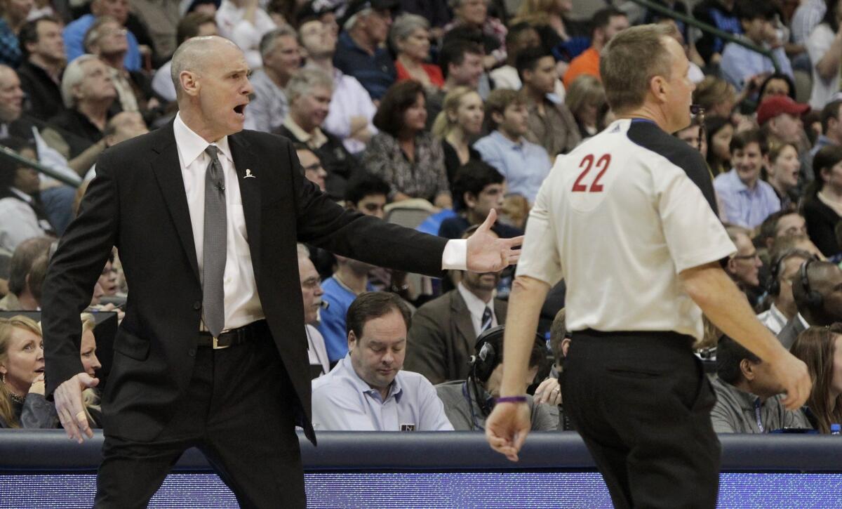 Dallas Mavericks Coach Rick Carlisle, left, argues a no call with referee Bill Spooner, right, during a game on March 25 at American Airlines Center in Dallas.