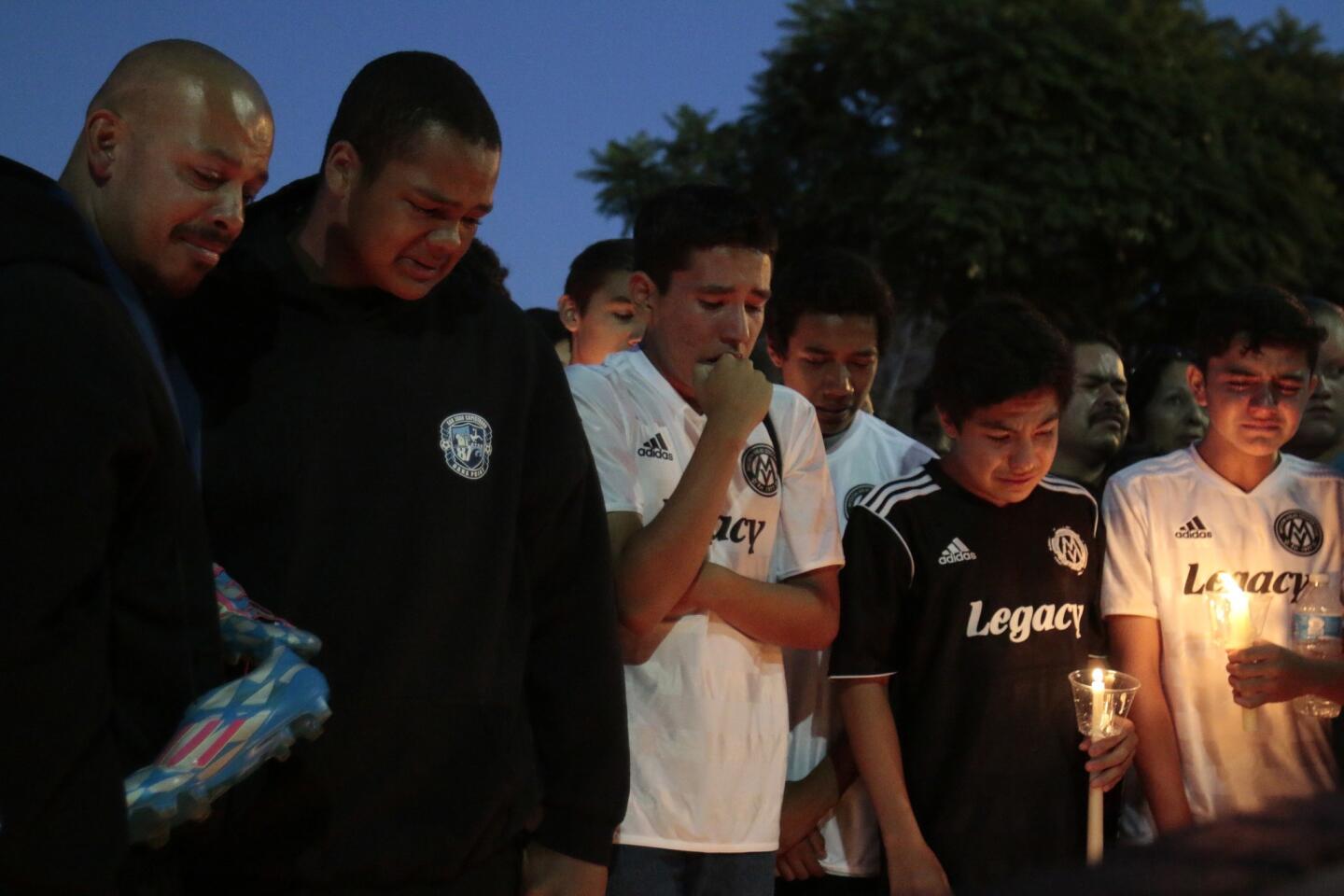 Ivan Melo, left, father of victim Matthew Melo, with his son's soccer teammates.