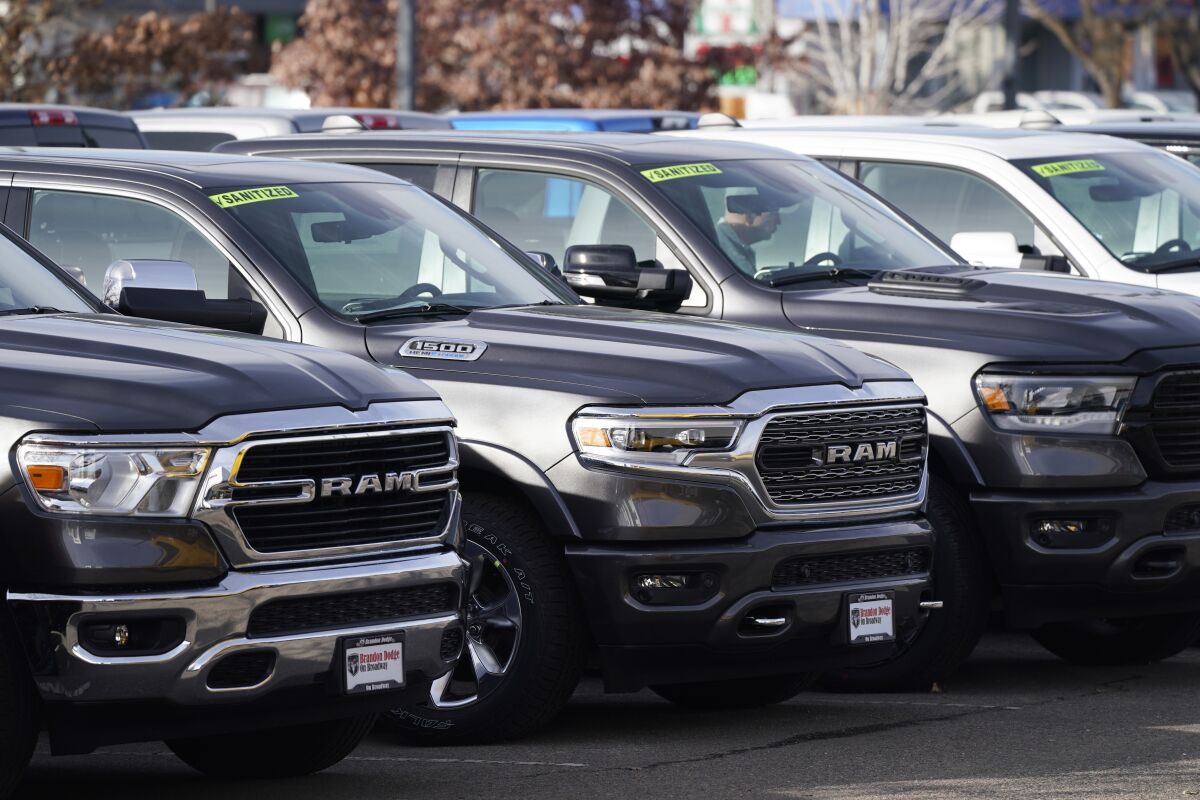 A long row of unsold 2020 pickup trucks sits at a Ram dealership Sunday, Dec. 27, 2020, in Littleton, Colo. A new government report says gas mileage for new vehicles dropped and pollution increased in model year 2019 for the first time in five years. (AP Photo/David Zalubowski)