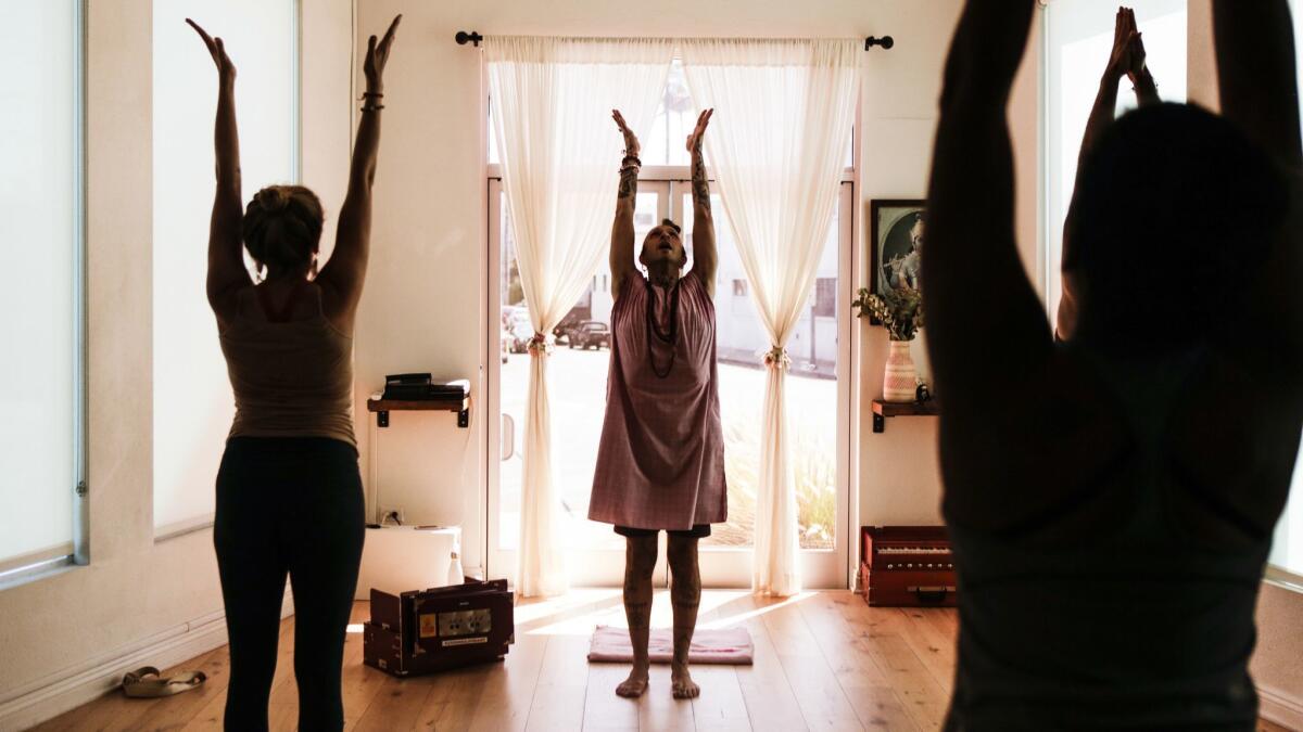 A yoga teacher leads a community class in Los Angeles.