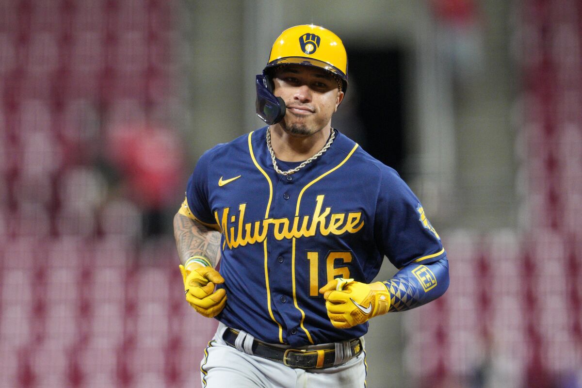 FILE - Milwaukee Brewers' Kolten Wong runs during a baseball game against the Cincinnati Reds, Sept. 22, 2022, in Cincinnati. Wong is staying in Milwaukee as the Brewers have picked up the $10 million 2023 team option on the veteran second baseman. (AP Photo/Jeff Dean, File)