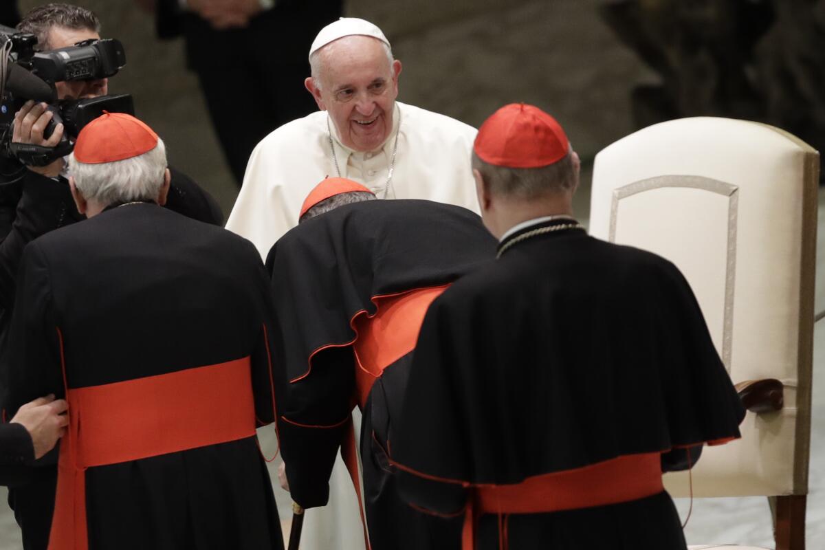 Pope Francis greets cardinals at the Vatican on Thursday.