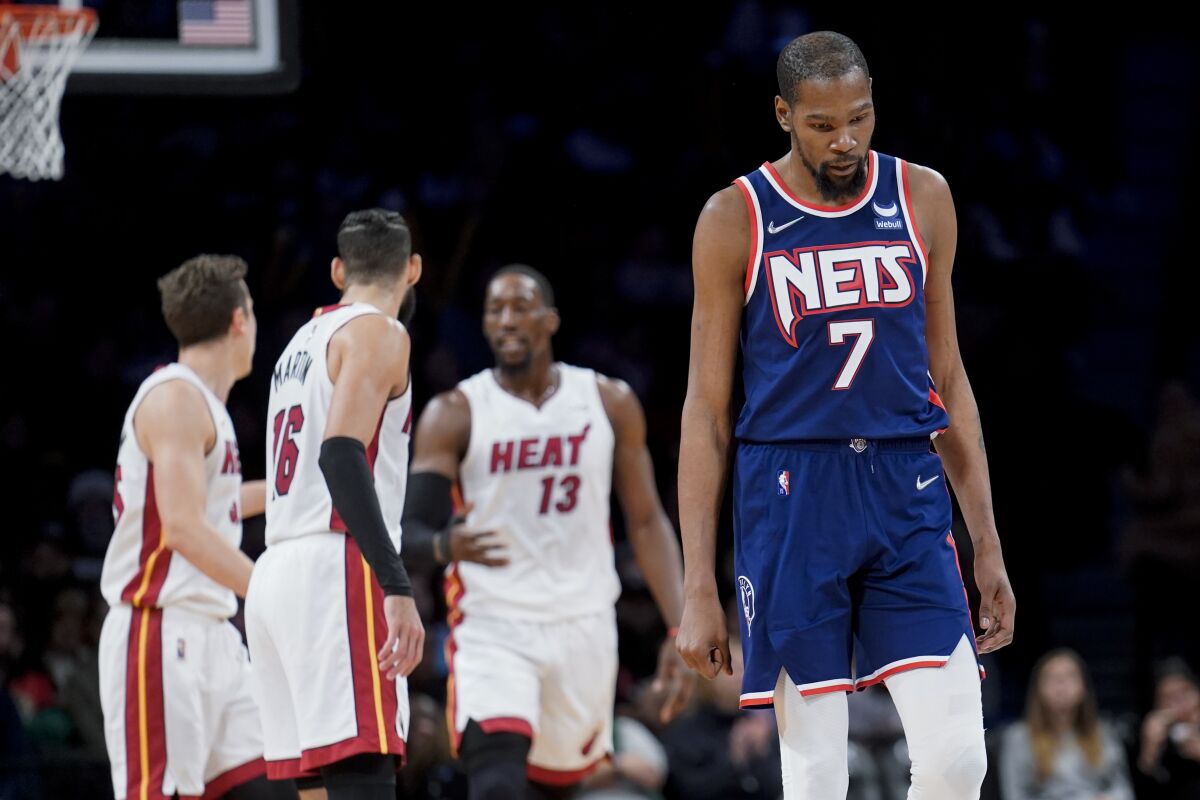 Brooklyn Nets forward Kevin Durant (7) reacts after Miami Heat center Bam Adebayo (13) scored in the second half of an NBA basketball game, Thursday, March 3, 2022, in New York. (AP Photo/John Minchillo)