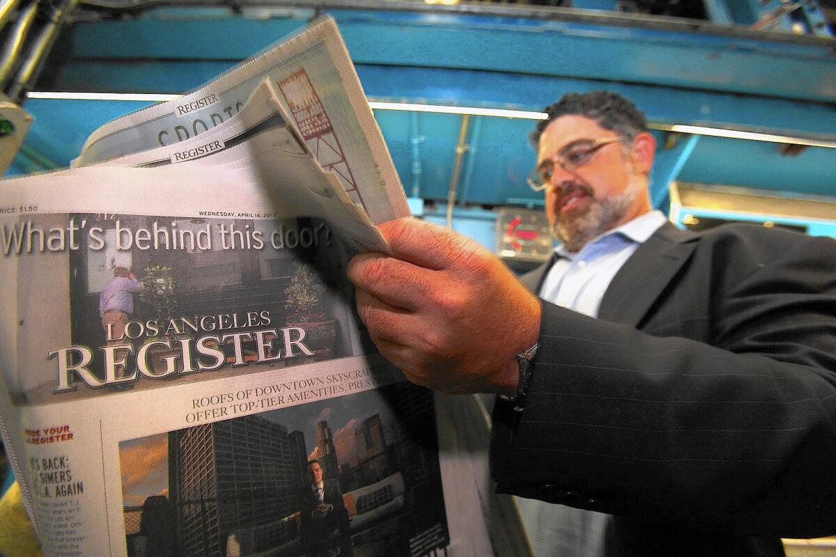 Freedom Communications reported that 29 newsroom employees lost their jobs amid the closure of the L.A. Register. Above, Freedom co-owner Eric Spitz peruses one of the first copies of the newspaper in April.