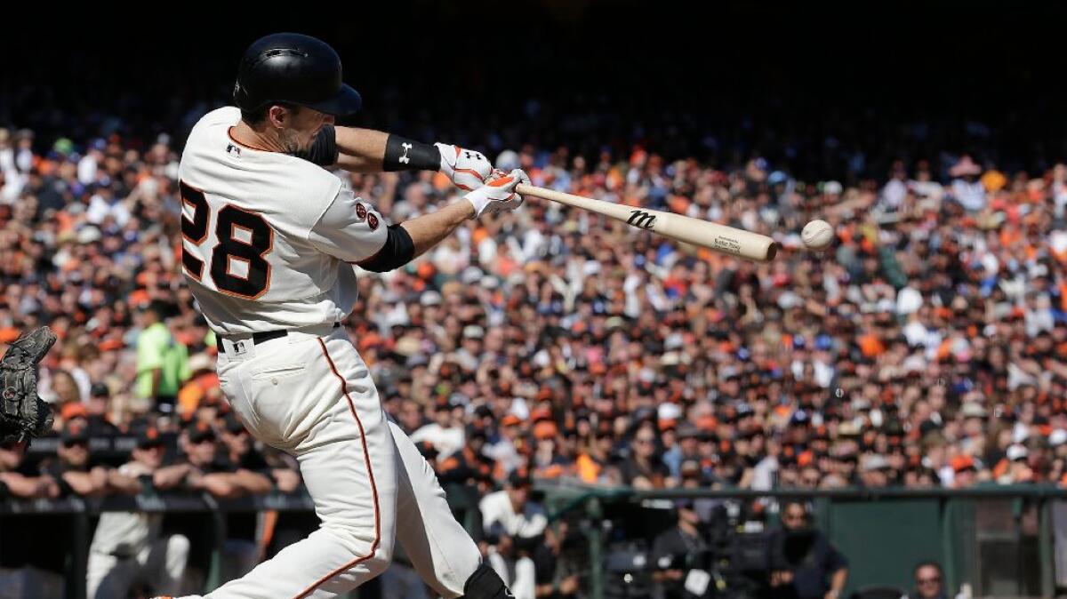 Giants catcher Buster Posey swings at a pitch during a game against the Dodgers on Saturday in San Francisco.