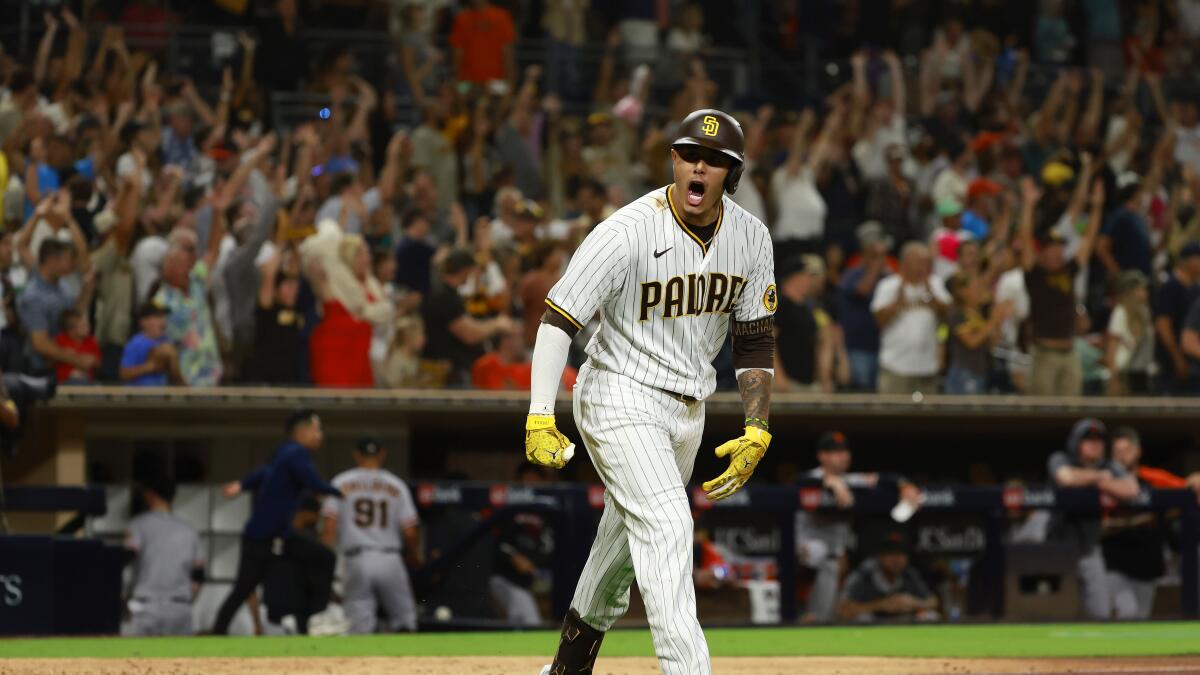 The San Diego Padres' Manny Machado is congratulated by teammate