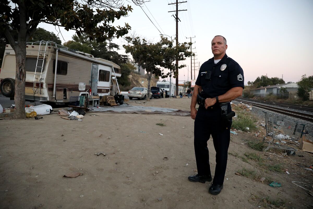 Sgt. Jaime Chacon stands near tracks in Lincoln Heights