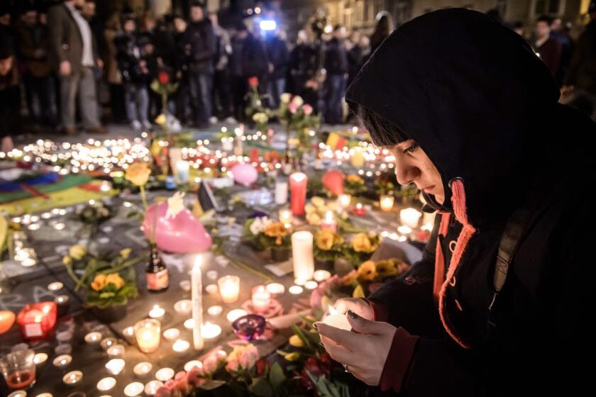 People gather and light candles at the Place de la Bourse during a vigil to pay tribute to the victims of the attacks in Brussels, Belgium on March 22.