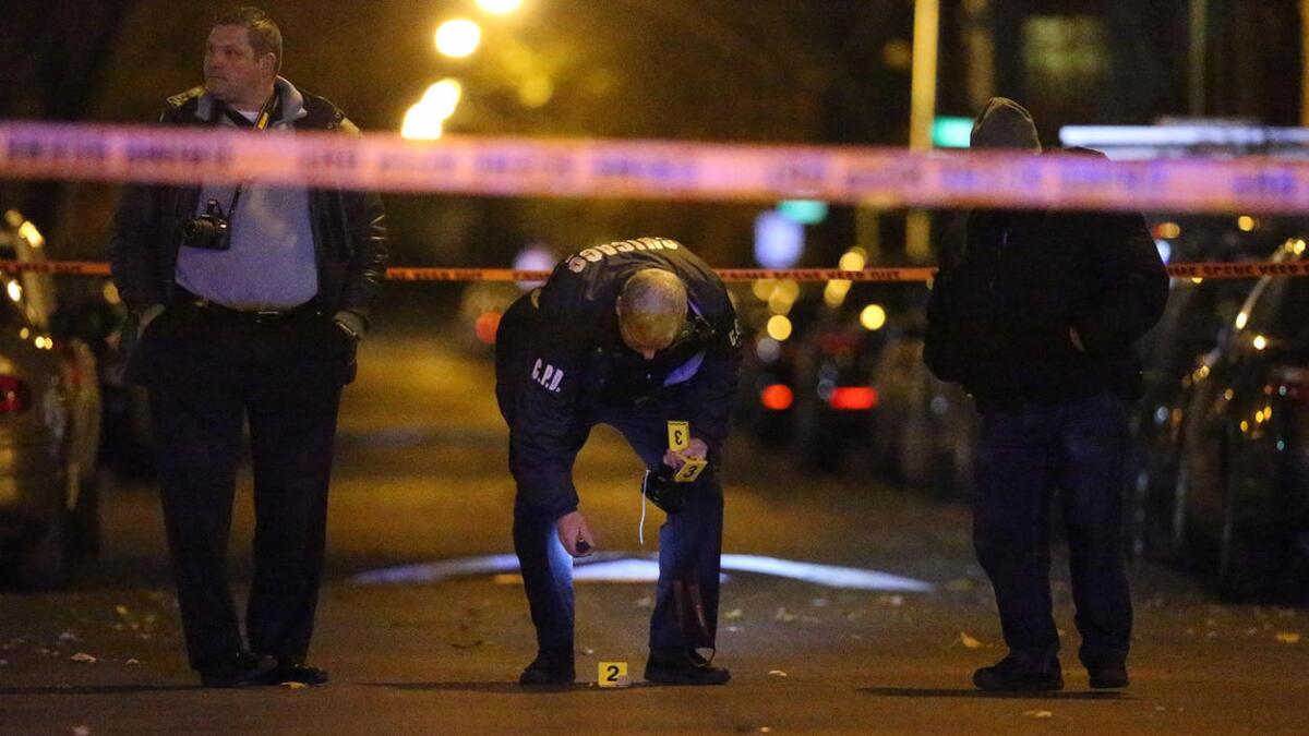 Members of the Chicago Police Department investigate the scene of a shooting on Wednesday night. It was the city's 701st homicide of 2016.