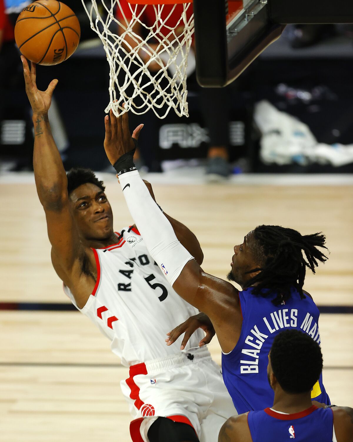 Toronto Raptors' Stanley Johnson (5) drives to the basket against Denver Nuggets' Tyler Cook (25) during the fourth quarter of an NBA basketball game Friday, Aug. 14, 2020, in Lake Buena Vista, Fla. (Mike Ehrmann/Pool Photo via AP)
