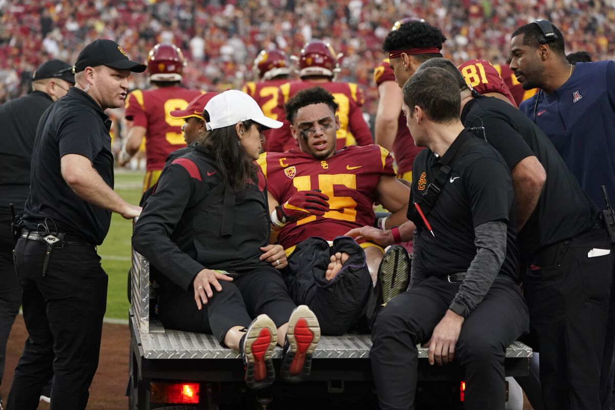 Southern California wide receiver Drake London is loaded onto a cart after an injury in the end zone after scoring a touchdown during the first half of an NCAA college football game against Arizona, Saturday, Oct. 30, 2021, in Los Angeles. (AP Photo/Marcio Jose Sanchez)