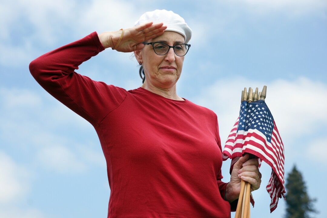 Alissa Rimmon greets a grave at Los Angeles National Cemetery.