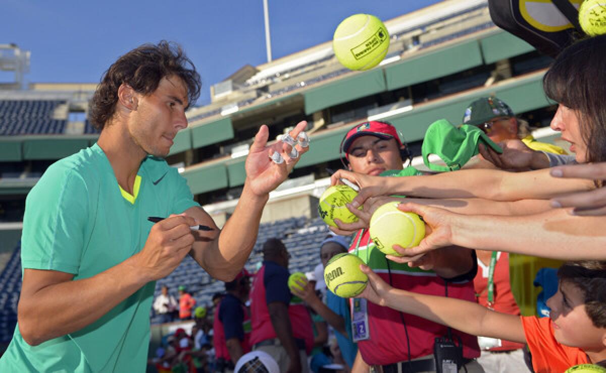 Rafael Nadal signs autographs for fans after winning the BNP Paribas Open in Indian Wells in March 2013. Nadal is among the players who are scheduled to compete in this year's tournament.