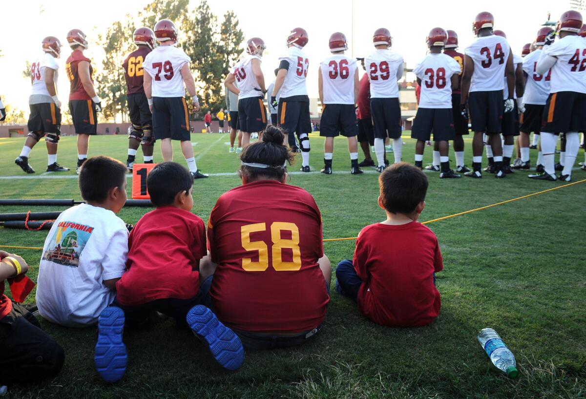 USC fans watch practice at Howard Jones Field in 2014. Fans will be allowed to watch select practices during fall camp this year.