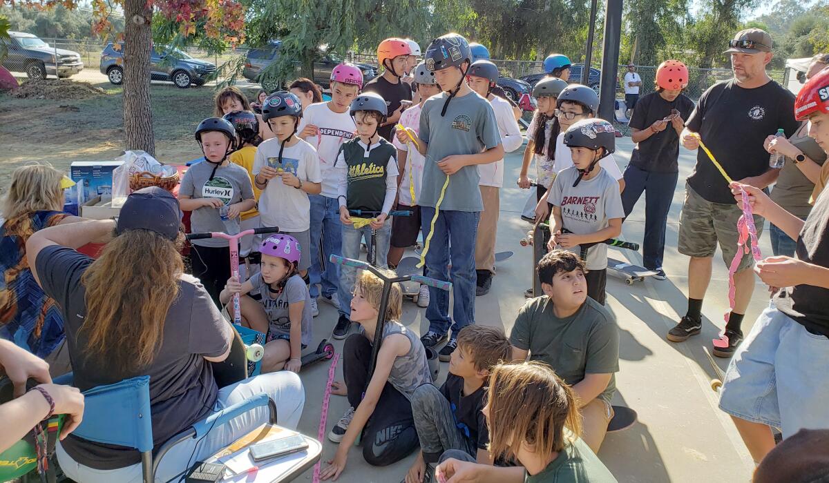 Skateboarders and scooter riders hear the results of raffle prize winners at the Skatepark Champions’ Fall Season Party.