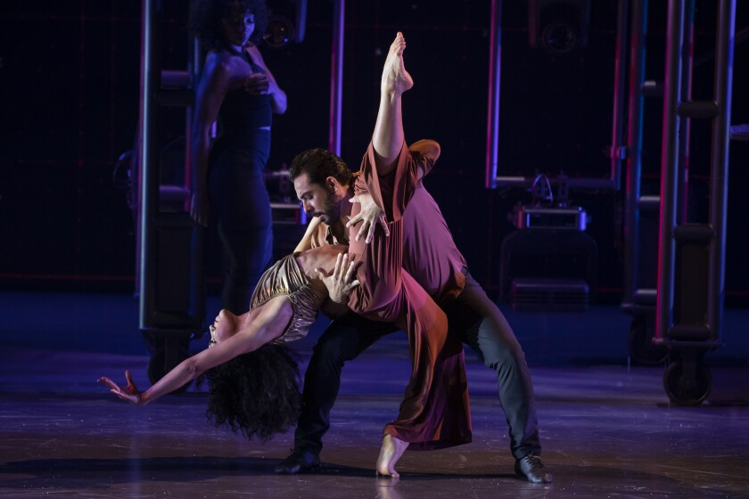 In dance, a man dips a woman onstage