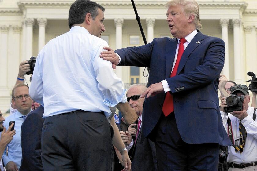 Republican presidential candidates Ted Cruz, left, and Donald Trump meet onstage during a rally outside the Capitol against the Iran nuclear agreement.