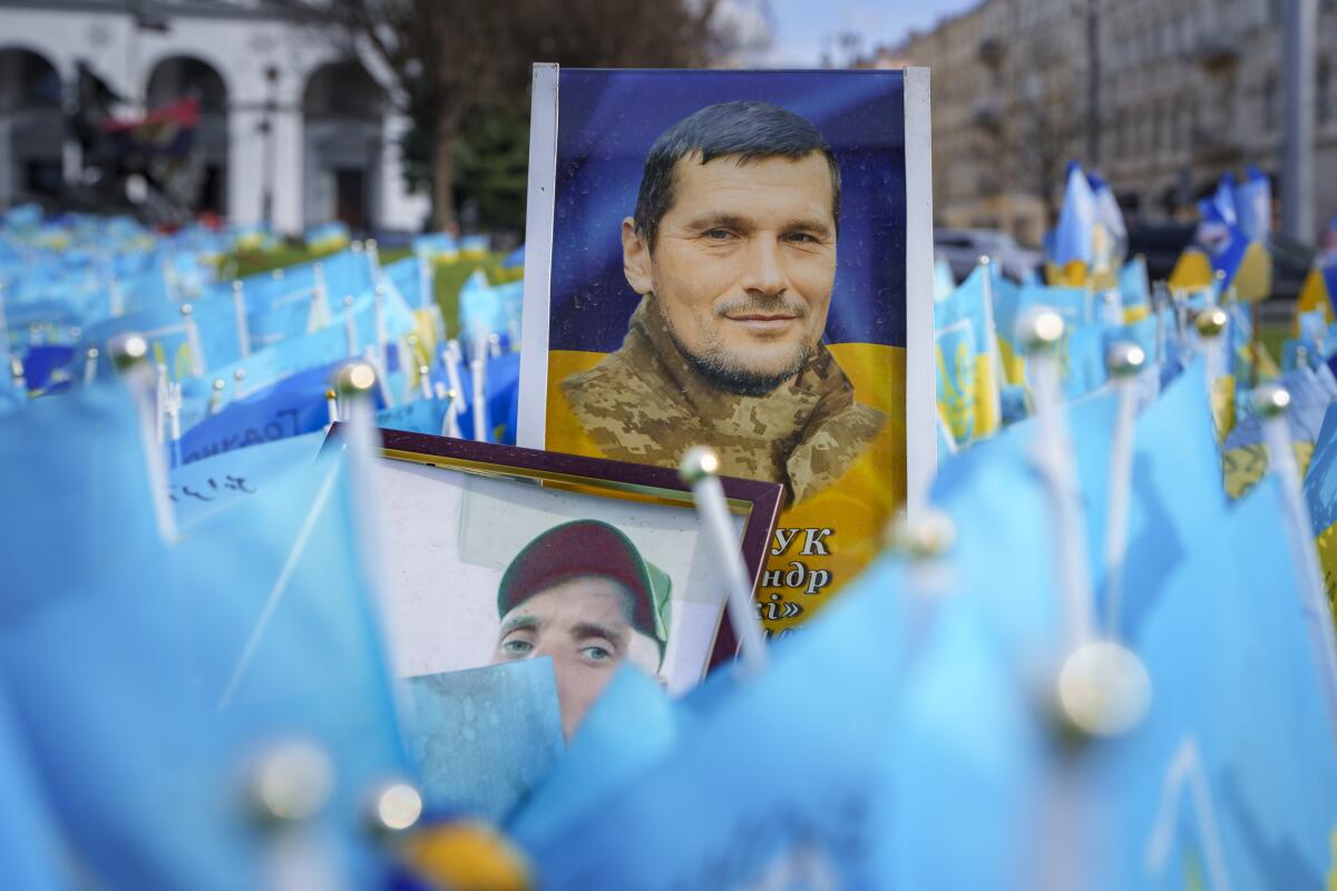 Photographs of fallen Ukrainian servicemen placed at a memorial in Independence Square, in Kyiv, Ukraine.