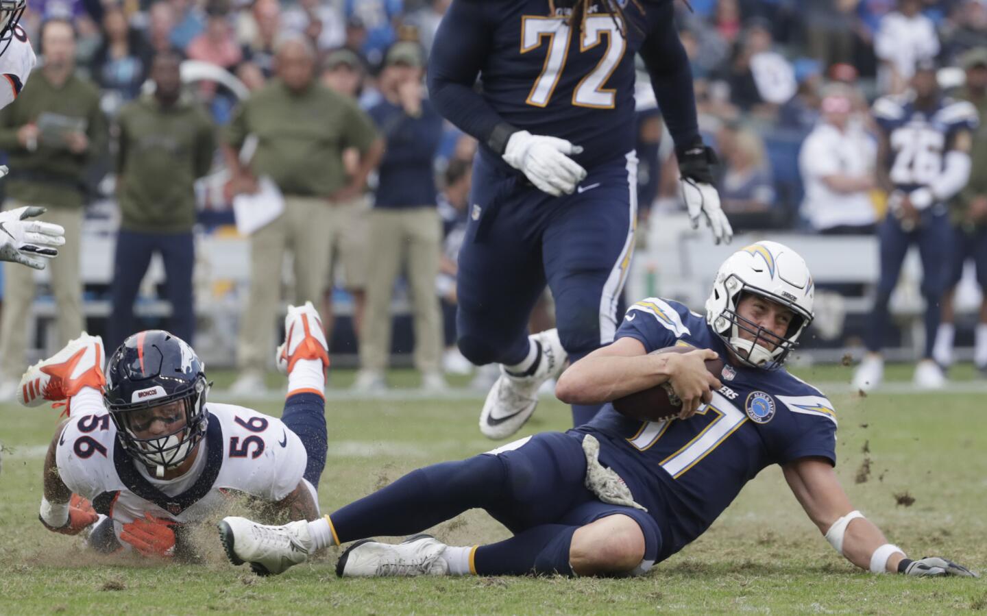 Chargers quarterback Philip Rivers slides to the ground after scrambling away from Denver Broncos linebacker Shane Ray during second half action at Stubhub Center.