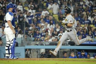 Pittsburgh Pirates' Jared Triolo, right, scores on double by Josh Palacios as Los Angeles Dodgers catcher Will Smith stands at the plate during the ninth inning of a baseball game Tuesday, July 4, 2023, in Los Angeles. (AP Photo/Mark J. Terrill)