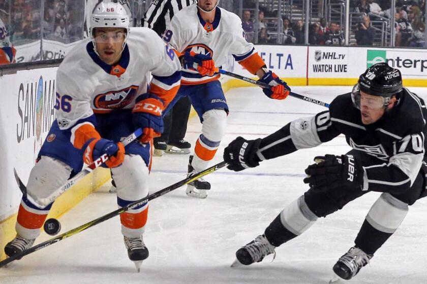 New York Islanders right winger Joshua Ho-Sang (66) and Los Angeles Kings left winger Tanner Pearson (70) battle in the first period of an NHL hockey game in Los Angeles, Sunday, Oct. 15, 2017. (AP Photo/Reed Saxon)