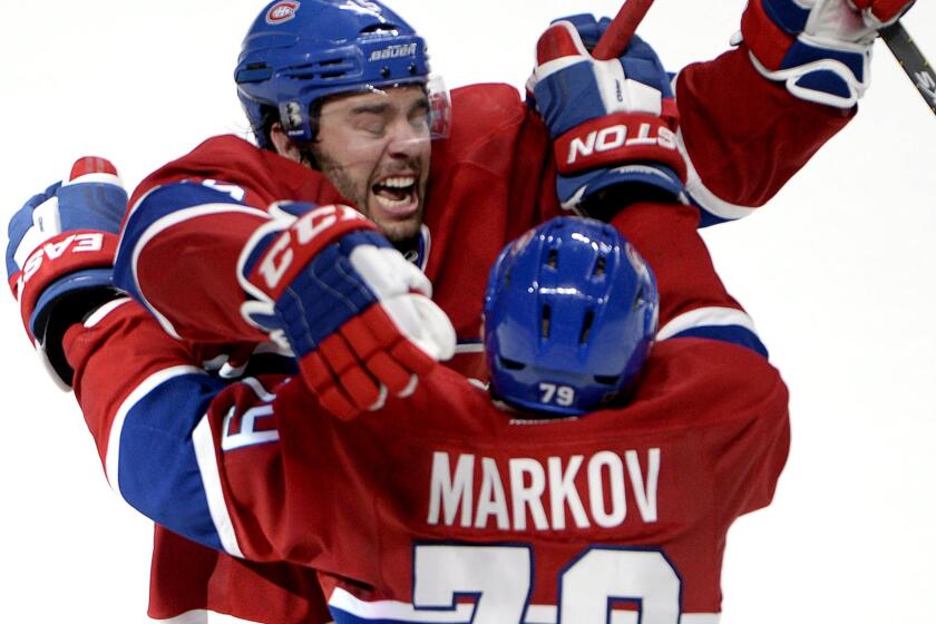 Canadiens right wing Pierre-Alexandre Parenteau celebrates with defenseman Andrei Markov after scoring the winning goal against the TLightning in the third period of Game 5 on Saturday night in Montreal.