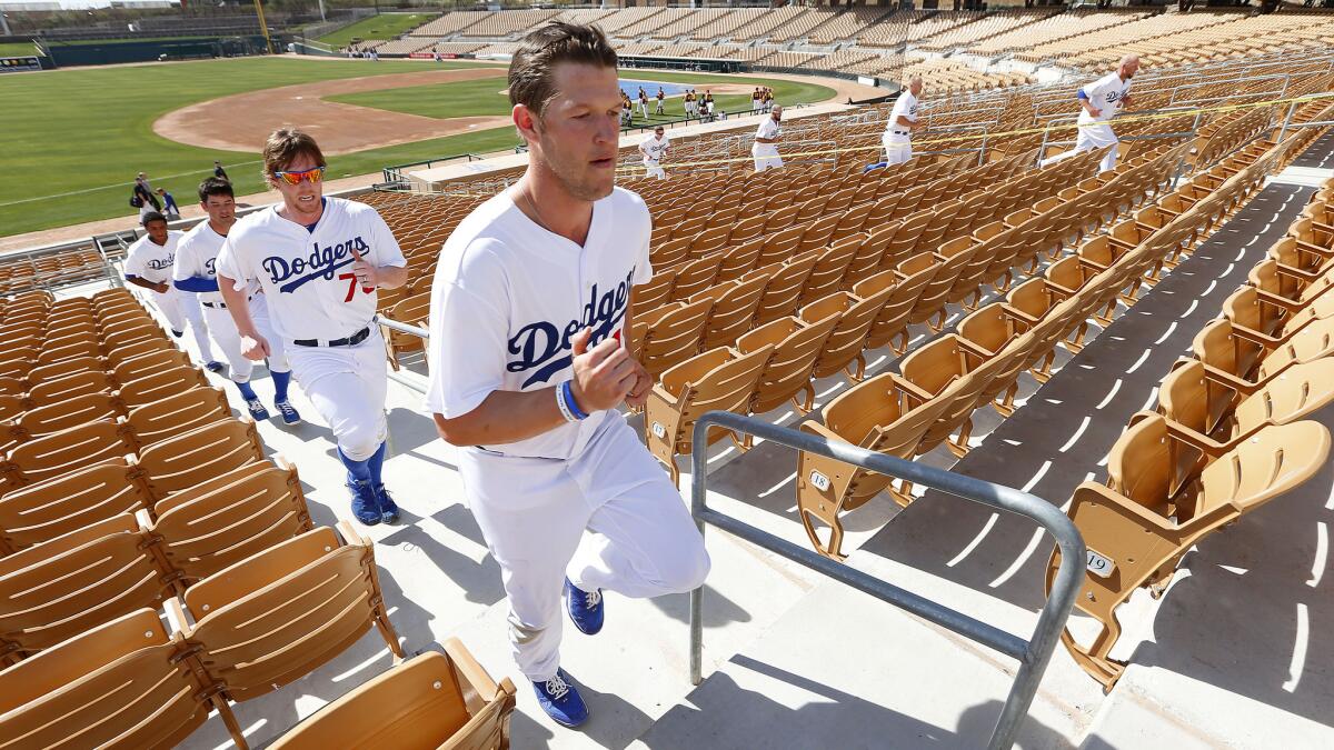 Pitcher Clayton Kershaw, foreground, runs up the stairs with teammates at the Dodgers' spring training complex in Glendale, Ariz., in February.