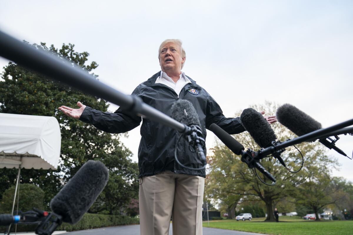 President Trump speaks to the media outside the White House before departing for California on Saturday morning.