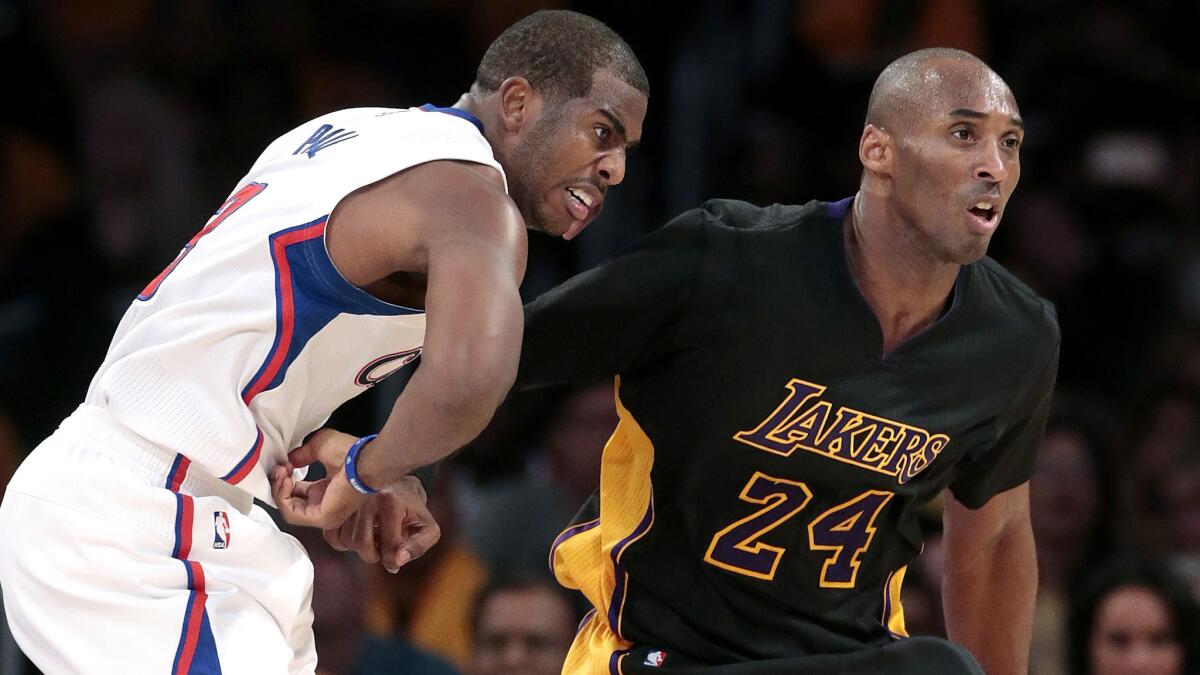 Clippers point guard Chris Paul and Lakers guard Kobe Bryant compete during a game at Staples Center on Oct. 31, 2014.