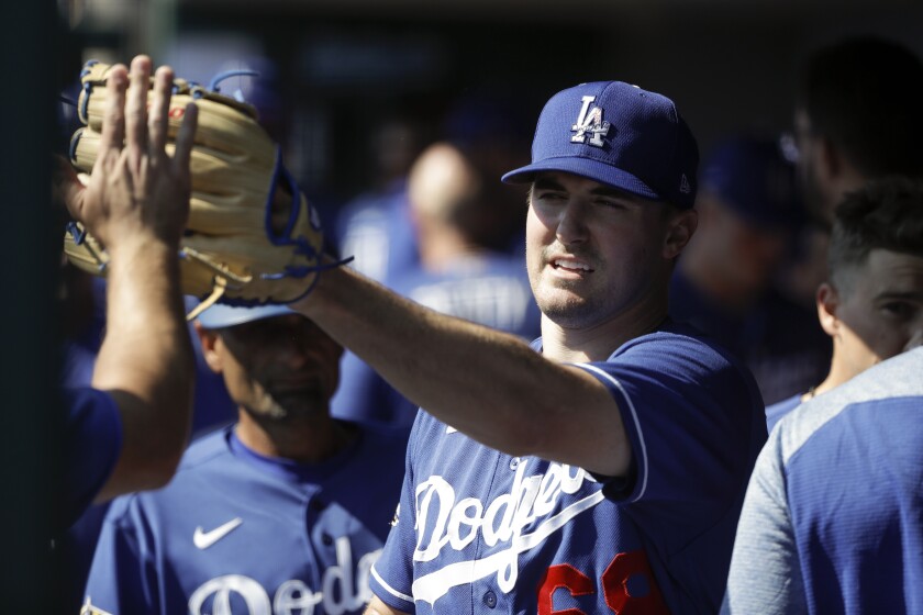 Los Angeles Dodgers pitcher Ross Stripling is greeted in the dugout.
