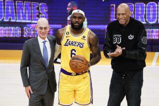 LOS ANGELES, CA - FEBRUARY 07: LeBron James, center, poses with Adam Silver.