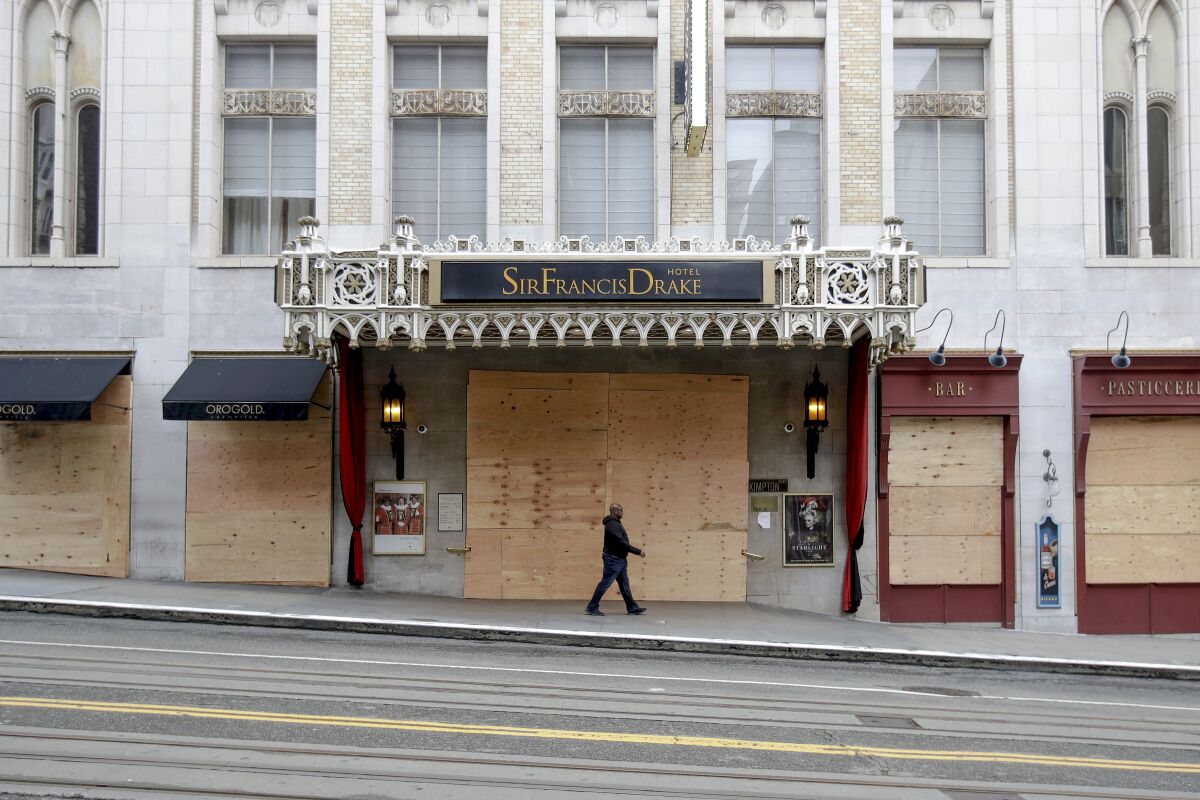 Boarded street-level doors and windows at the Sir Francis Drake Hotel. 