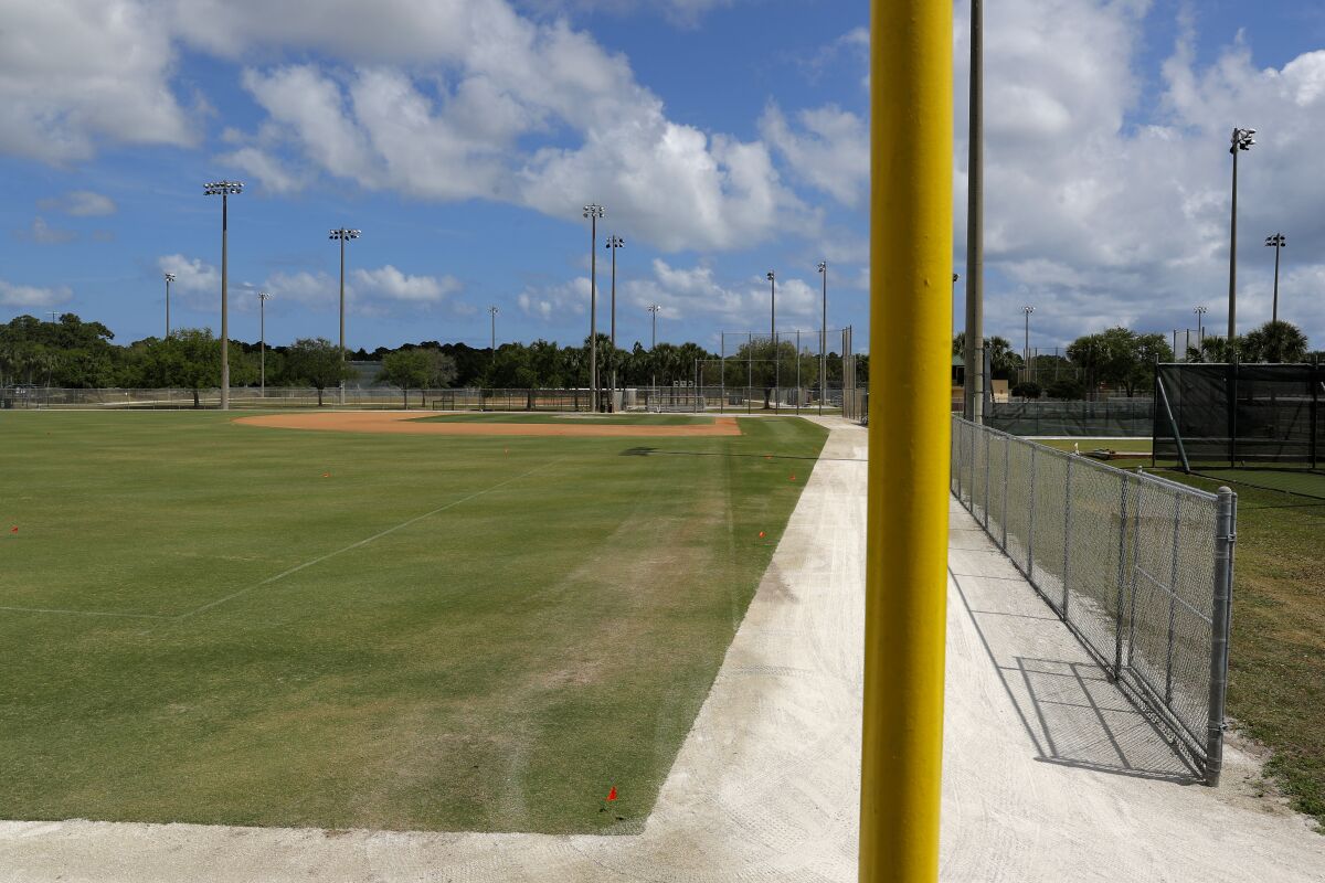 An empty practice field is seen at the Miami Marlins spring training baseball facility, Monday, March 16, 2020, in Jupiter, Fla. On Sunday night, the Centers for Disease Control and Prevention recommended gatherings of 50 people or more be canceled or postponed across the country for the next eight weeks. Major League Baseball planned to update teams Monday on its health policy.(AP Photo/Julio Cortez)