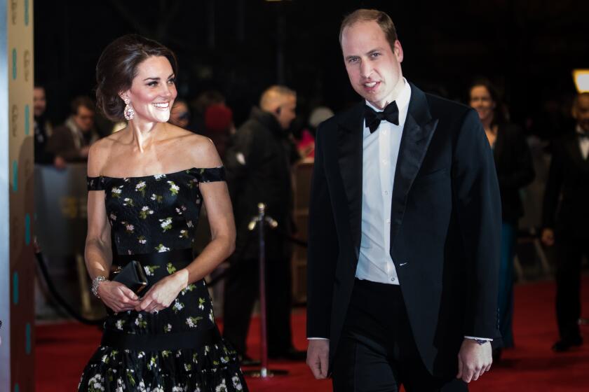 Catherine and Prince William walk a red carpet in formalwear