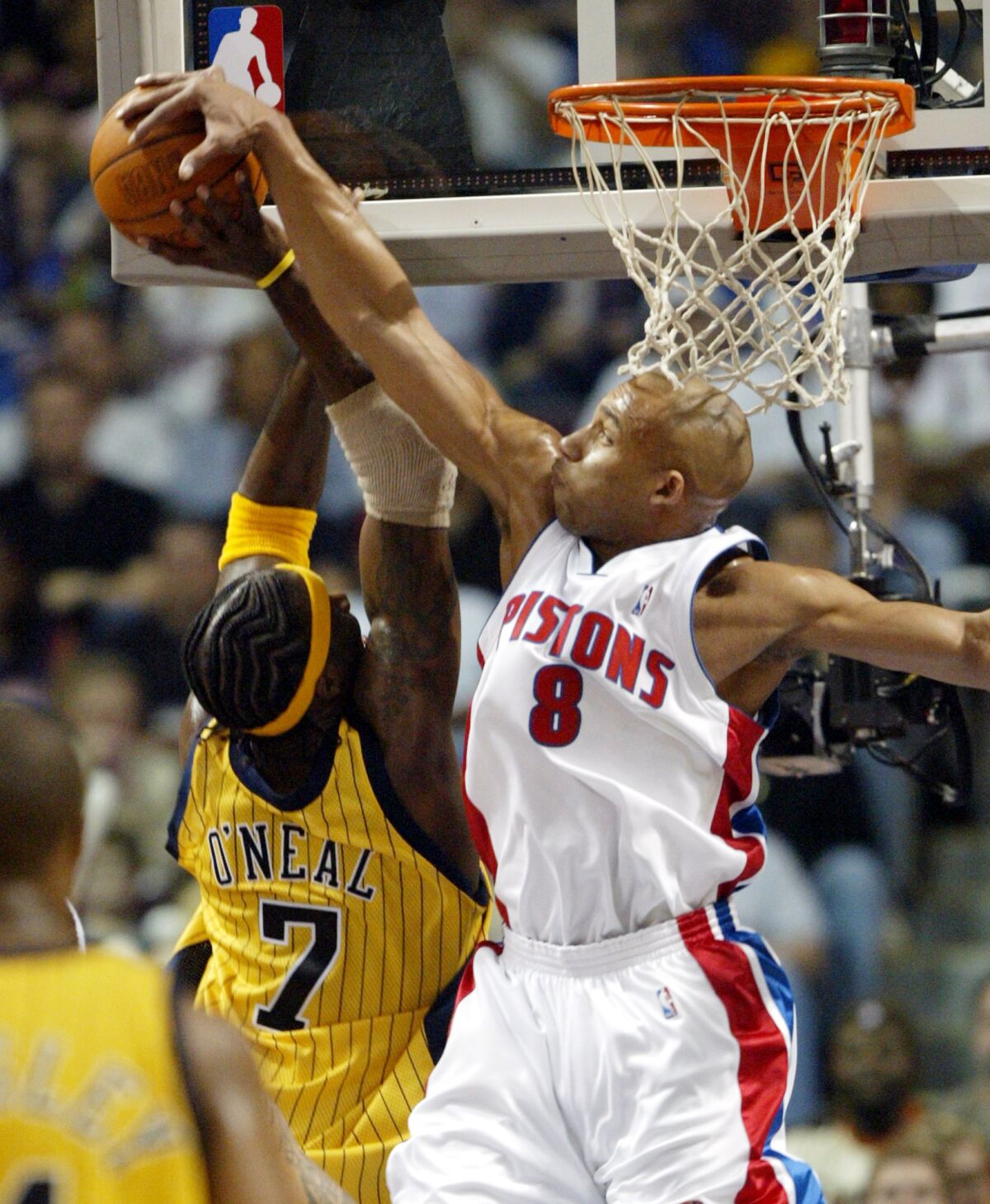 Detroit Pistons forward Darvin Ham blocks a shot by Indiana Pacers forward Jermaine O'Neal.
