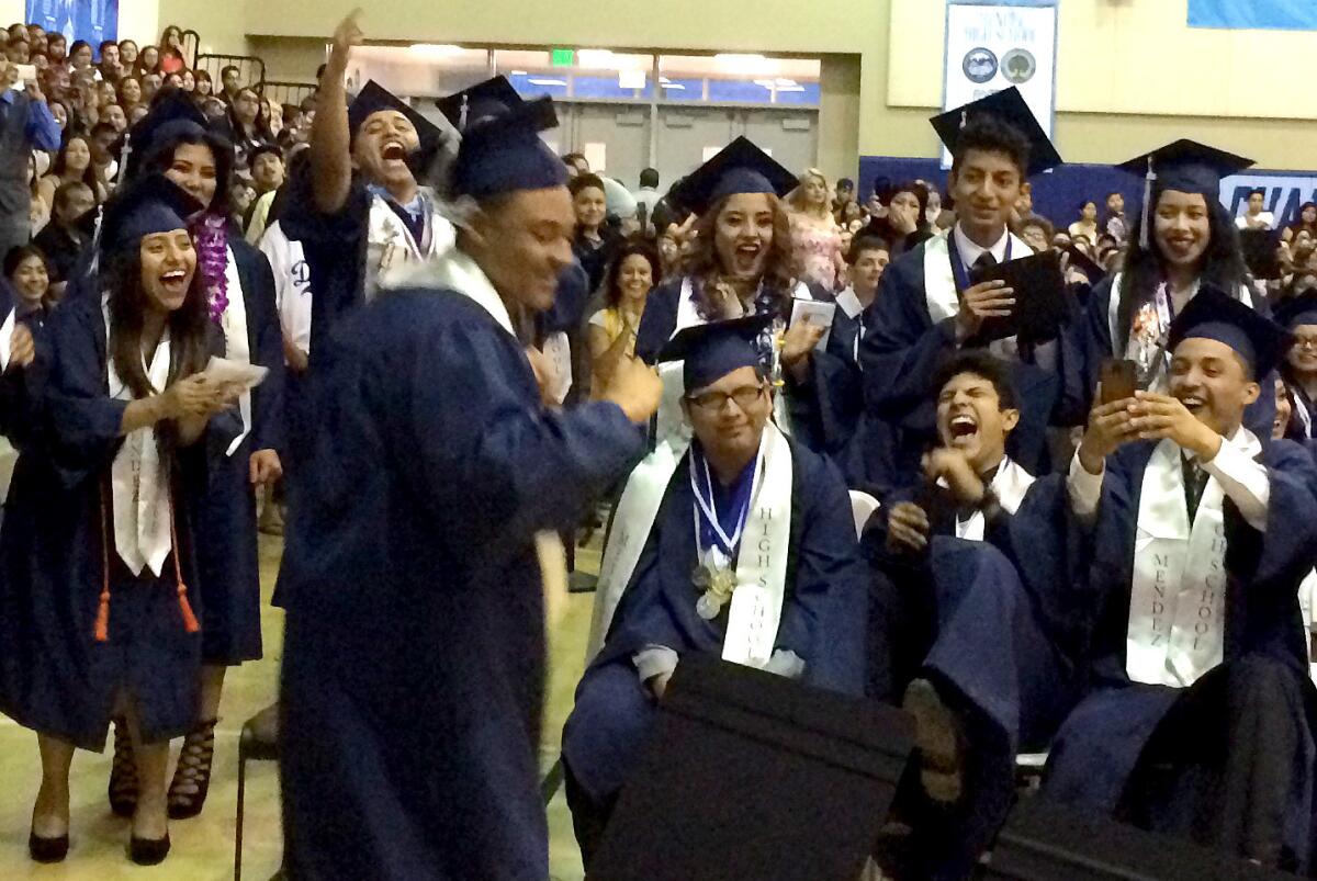Students celebrate at a graduation at Mendez High School, named for human rights activist Sylvia Mendez.