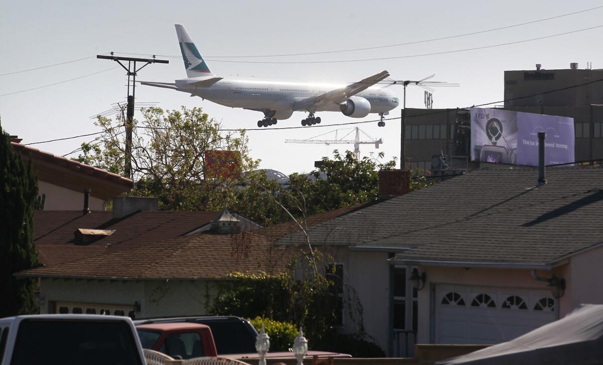 The view from Kittyhawk Avenue in Westchester as an airliner comes in for a landing on the north runway at Los Angeles International Airport.