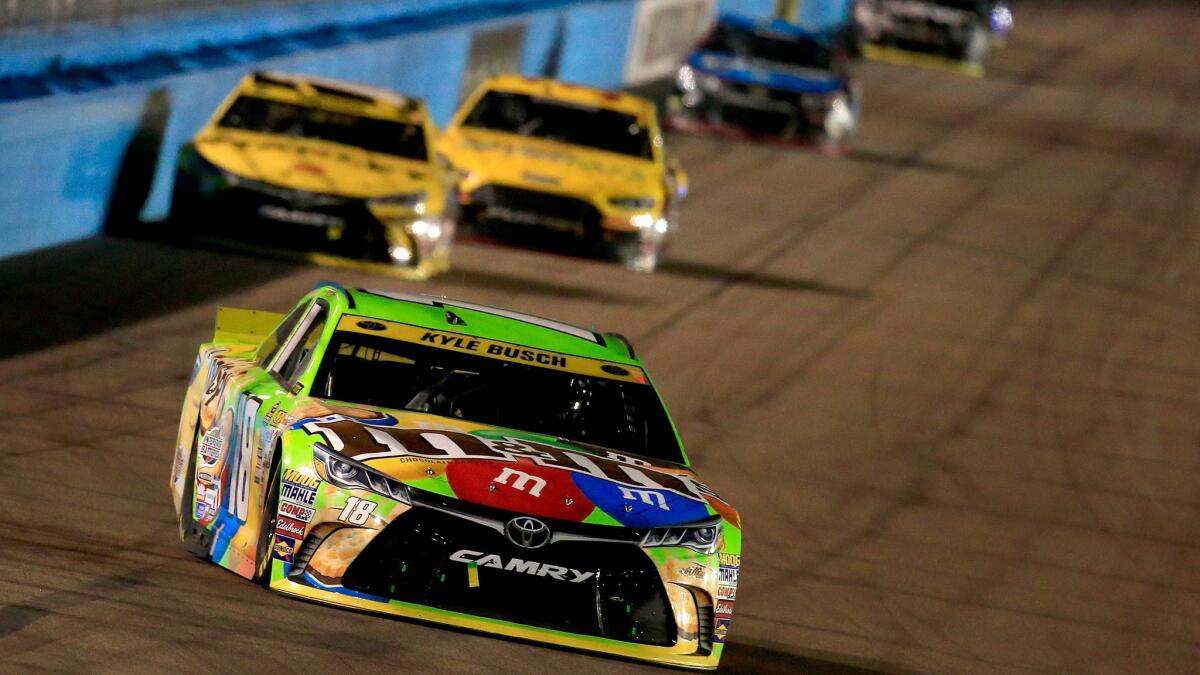 Kyle Busch leads a pack of NASCAR drivers into a turn during the Sprint Cup Series race at Phoenix International Raceway on Sunday.